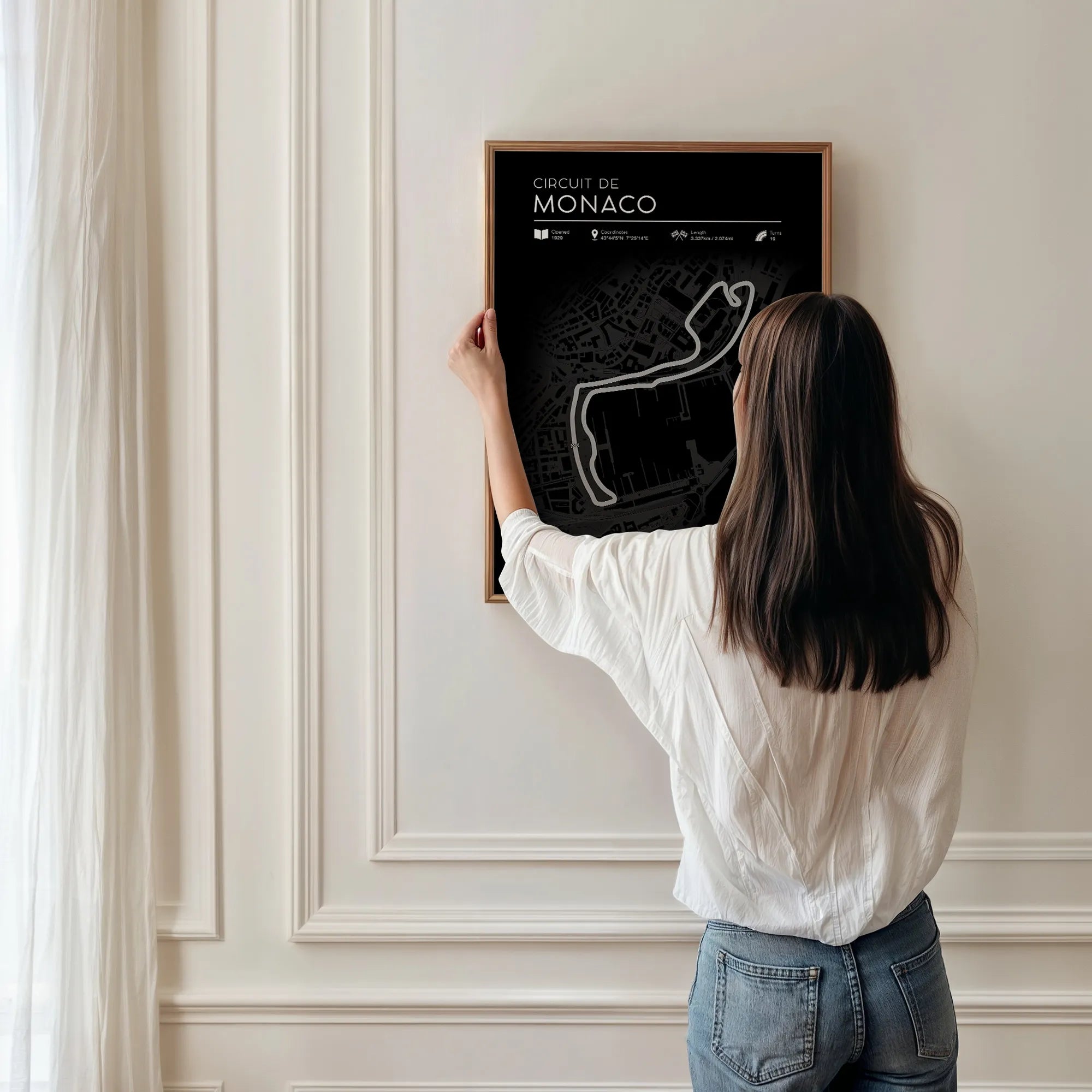 Woman hanging framed Monaco F1 Track Poster – stylish Formula 1 wall decor for fans and collectors