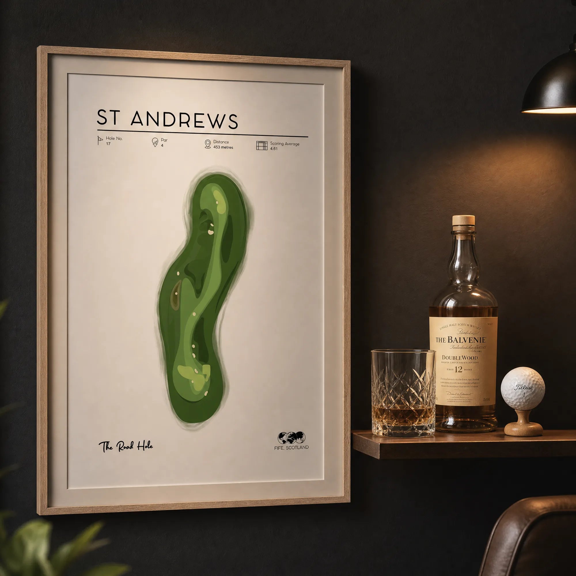Golf prints for office, framed St Andrews golf art on charcoal wall, single malt and crystal glass, warm evening interior