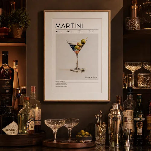 Framed Martini cocktail print as bar wall art above a stocked home bar with bottles and glassware