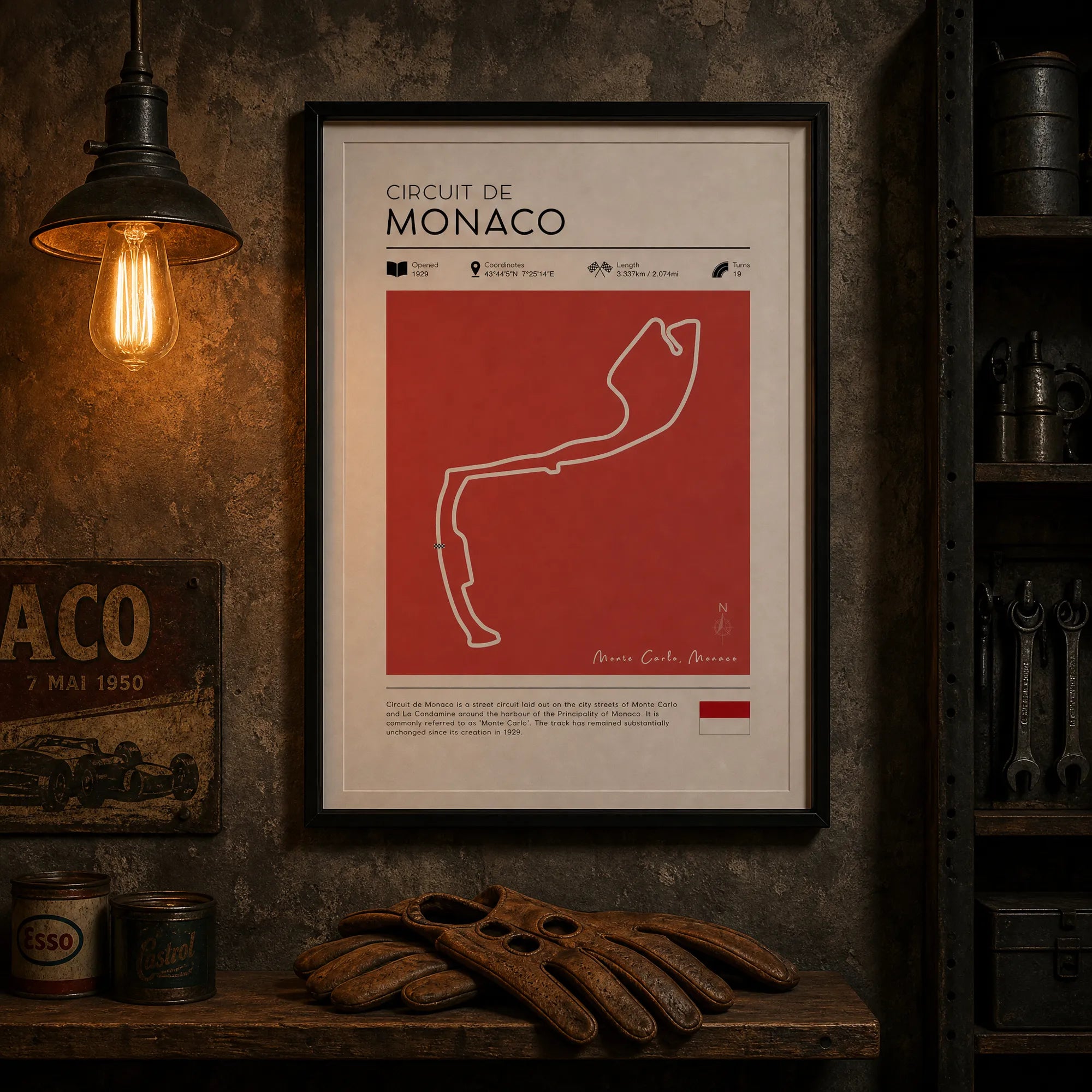 Framed poster of Circuit de Monaco on the wall of a car workshop with vintage decor.