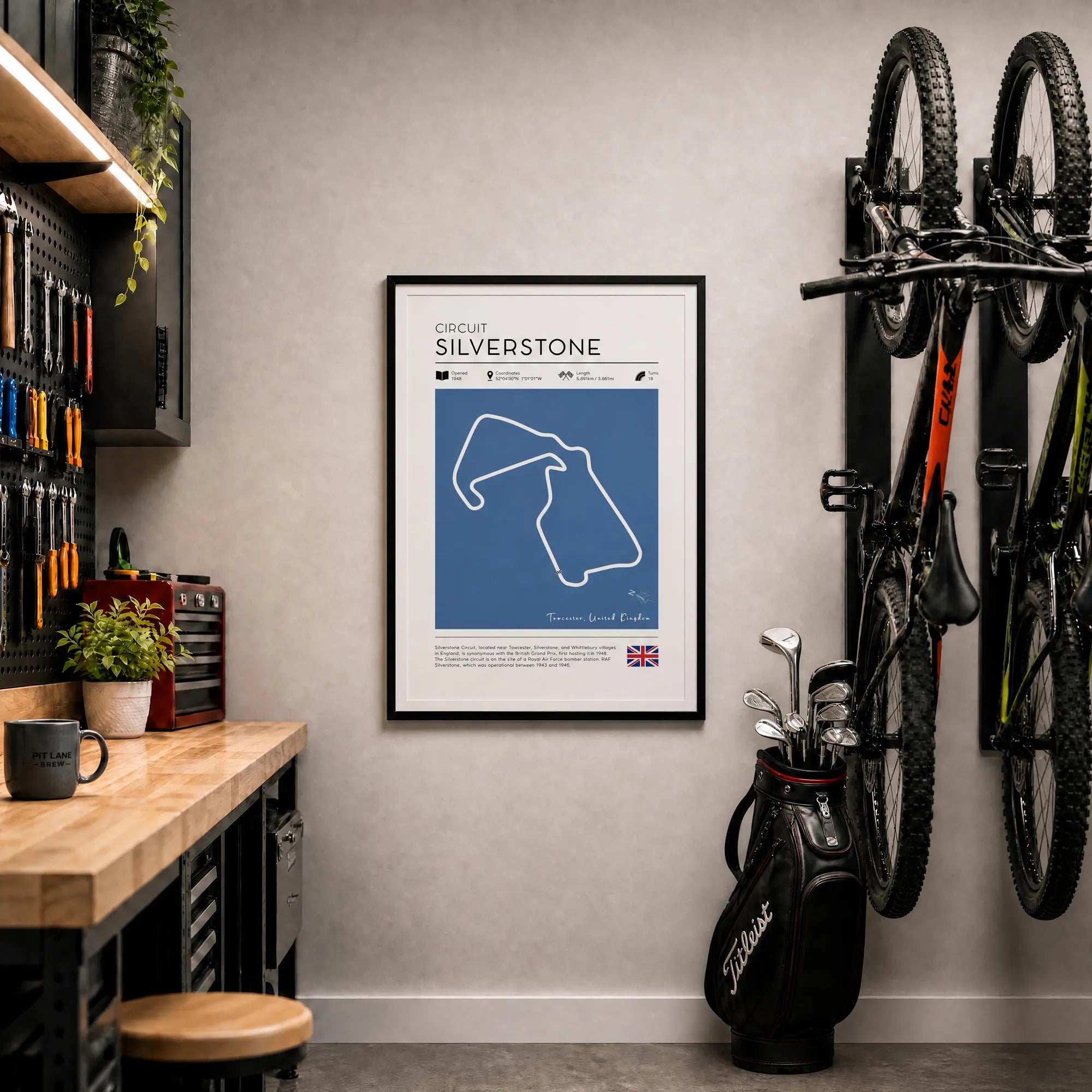 Silverstone F1 poster framed on garage wall with mountain bikes golf bag