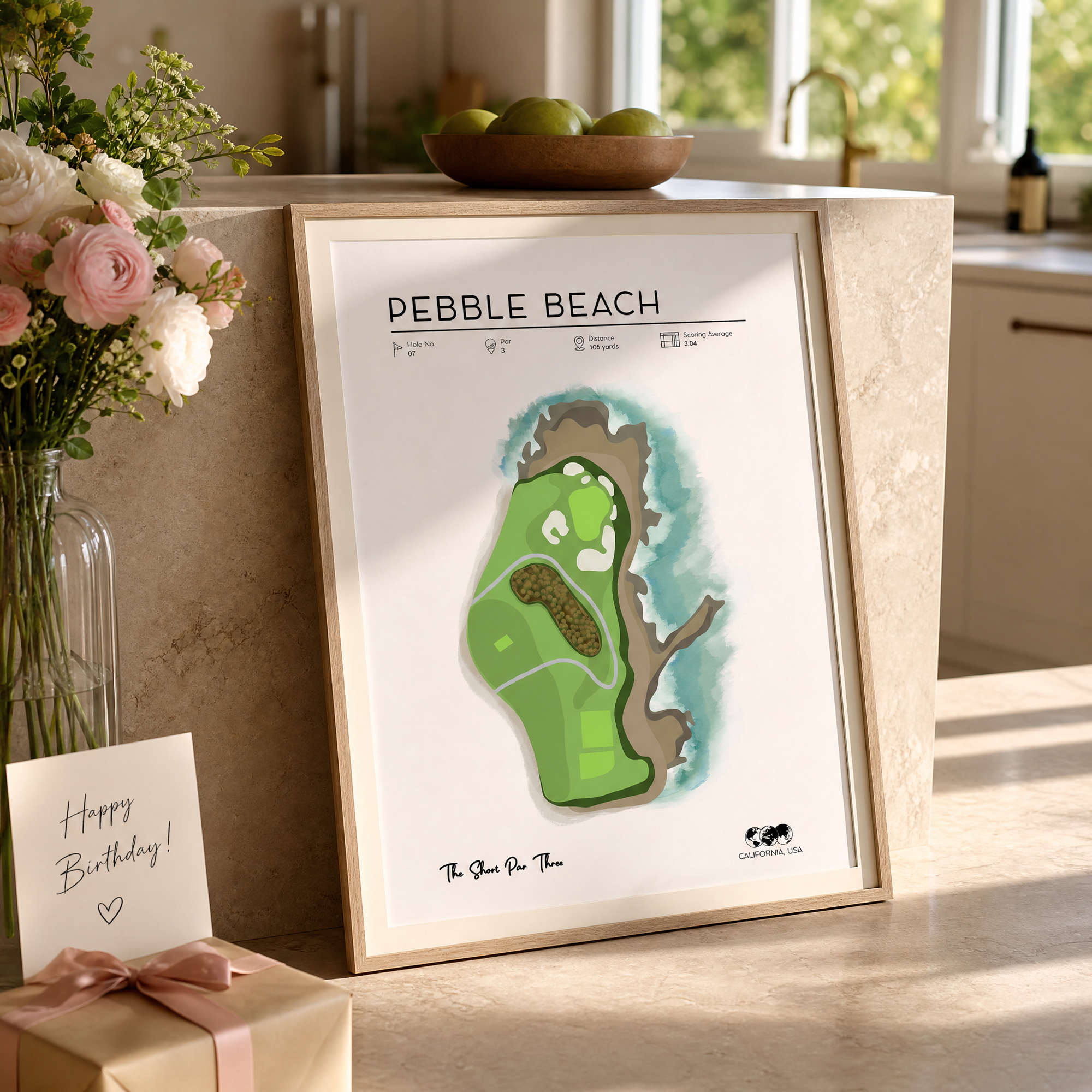 Pebble Beach golf course print as a unique golf gift for her, unwrapped on a kitchen island, morning light, light oak frame