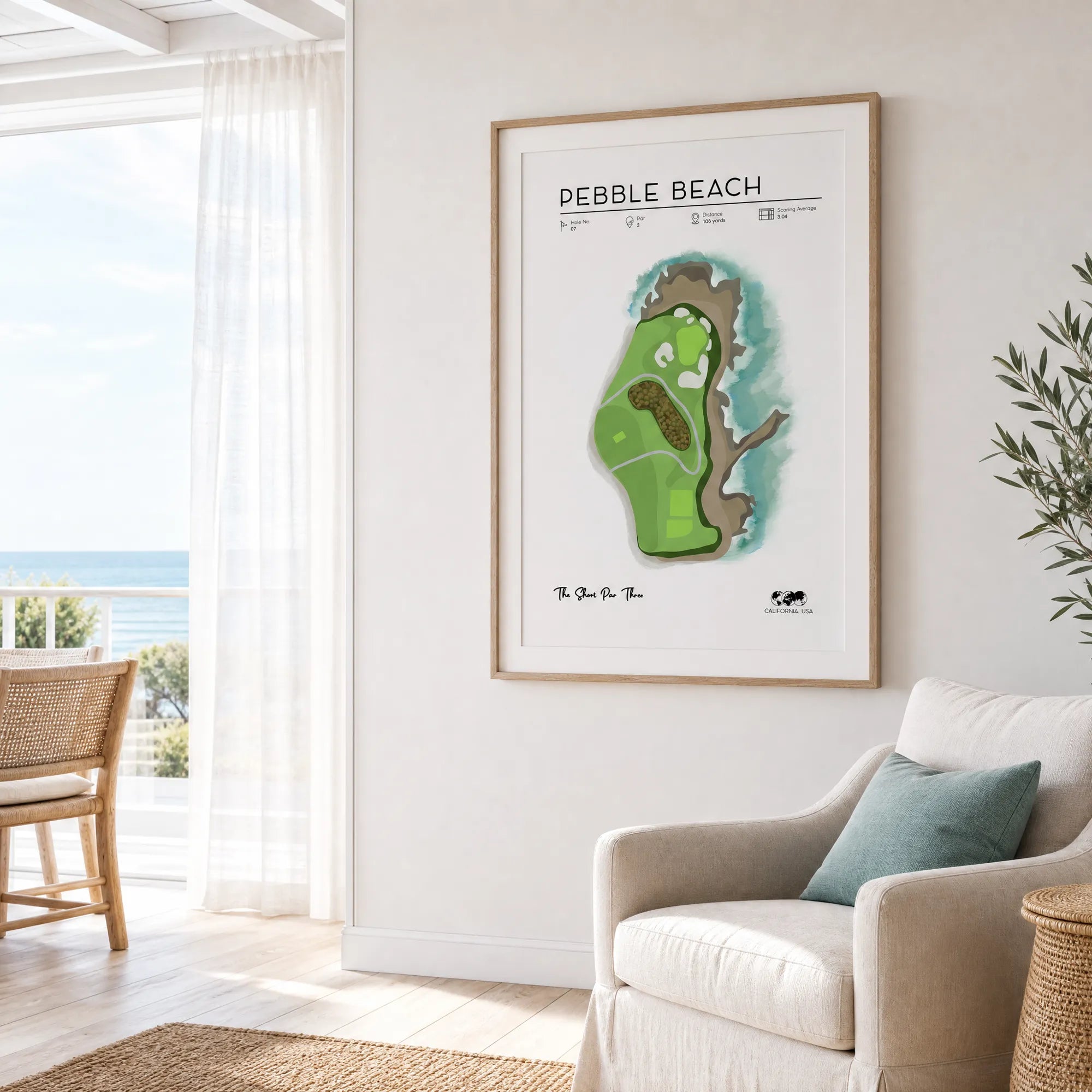 Framed Pebble Beach golf course print on a teal-grey living room wall, light oak frame, wide white mat, Scandinavian interior